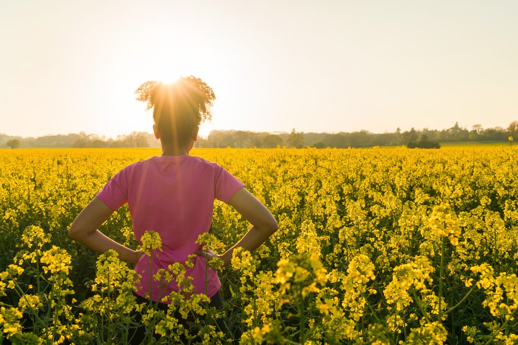 Woman standing in a field of yellow flowers representing successful treatment of her treatment-resistant depression in Arizona. Learn more here.